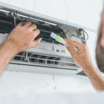 selective-focus-of-repairman-cleaning-air-conditioner-with-brush.jpg